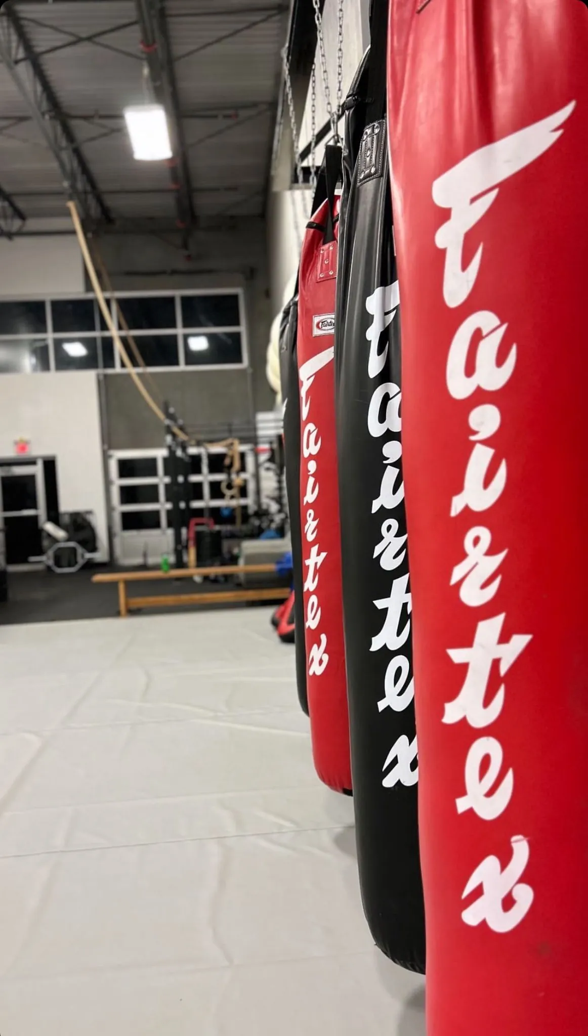Fairtex heavy bags hanging in the striking zone at Mission BJJ